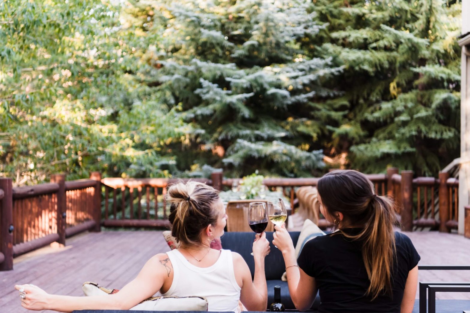 two people enjoying a glass of wine on deck of AvantStay home