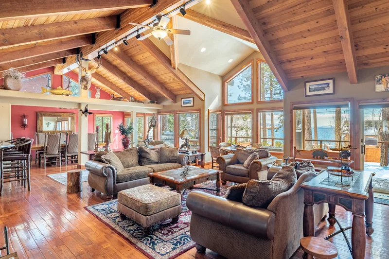 cozy log cabin with big windos and brown leather sofa