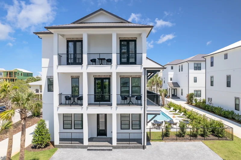 3 story white and minimalist house with a swimming pool