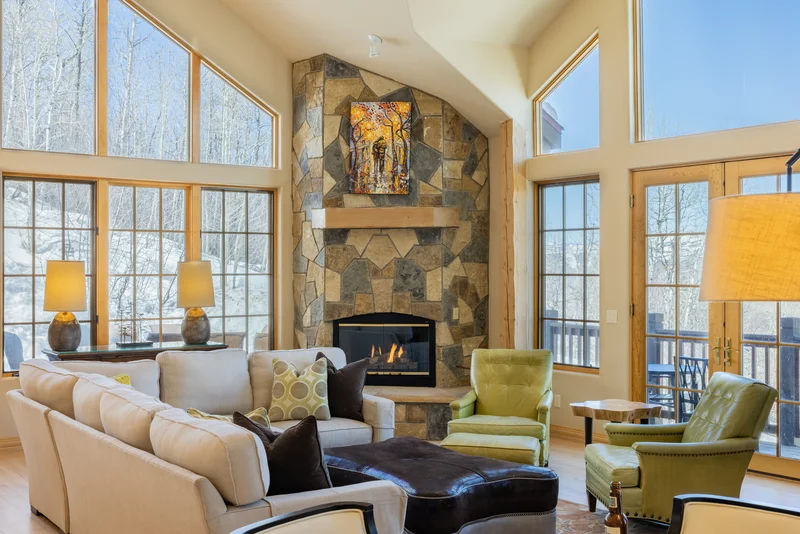 cozy cottage cabin with big windows and fireplace and mosaic wall making it the best vail airbnb