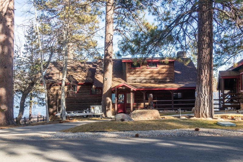 log cabin by the lake fronting two large trees making it the best big bear cabin for large groups