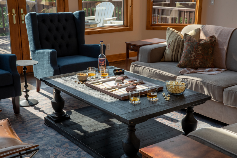 black wood table with snacks and scotch on the rocks