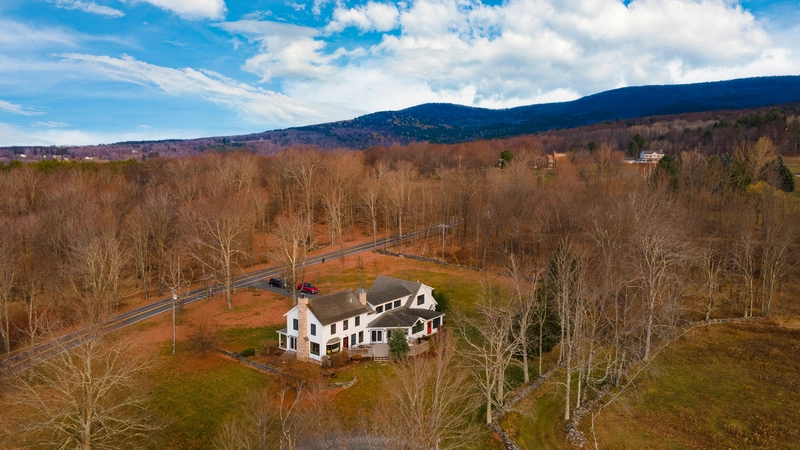 a European house in the middle of the woods during the fall season