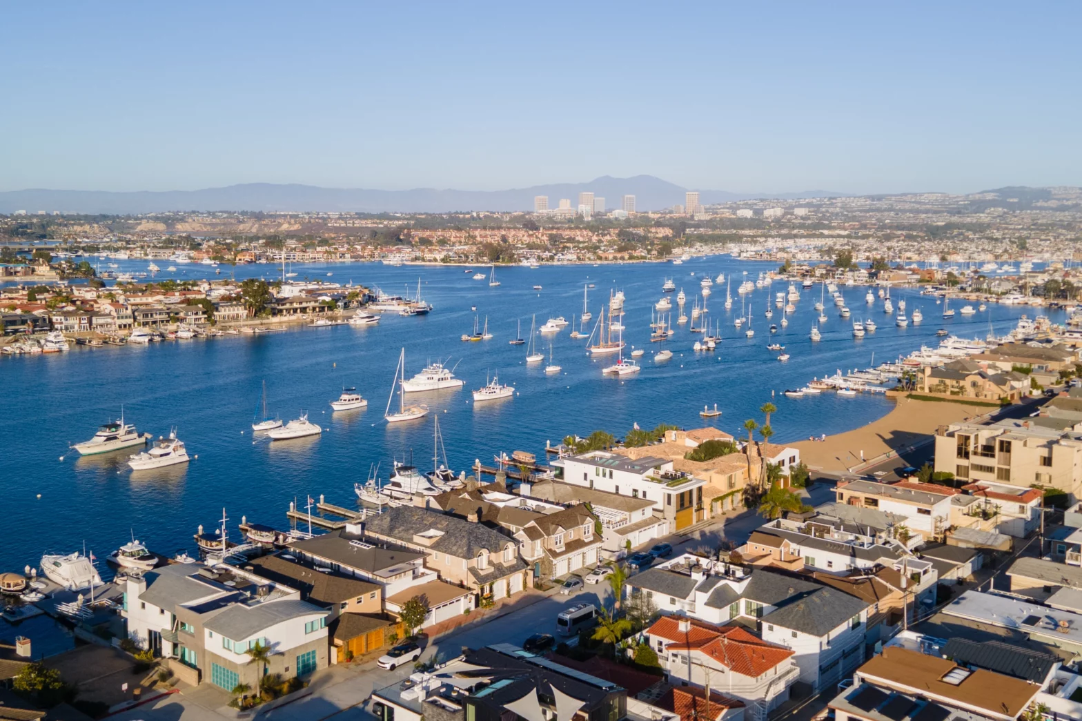 royal blue lagoon with hundreds of yacht boats and white sails