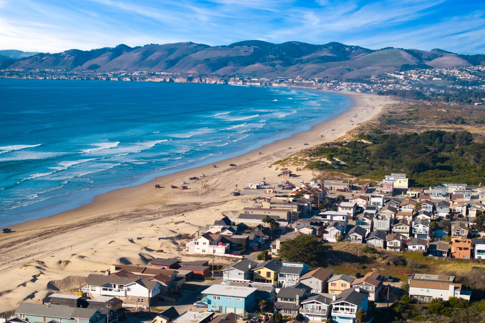 brown beach sands and blue waves of the sea on a sunny day