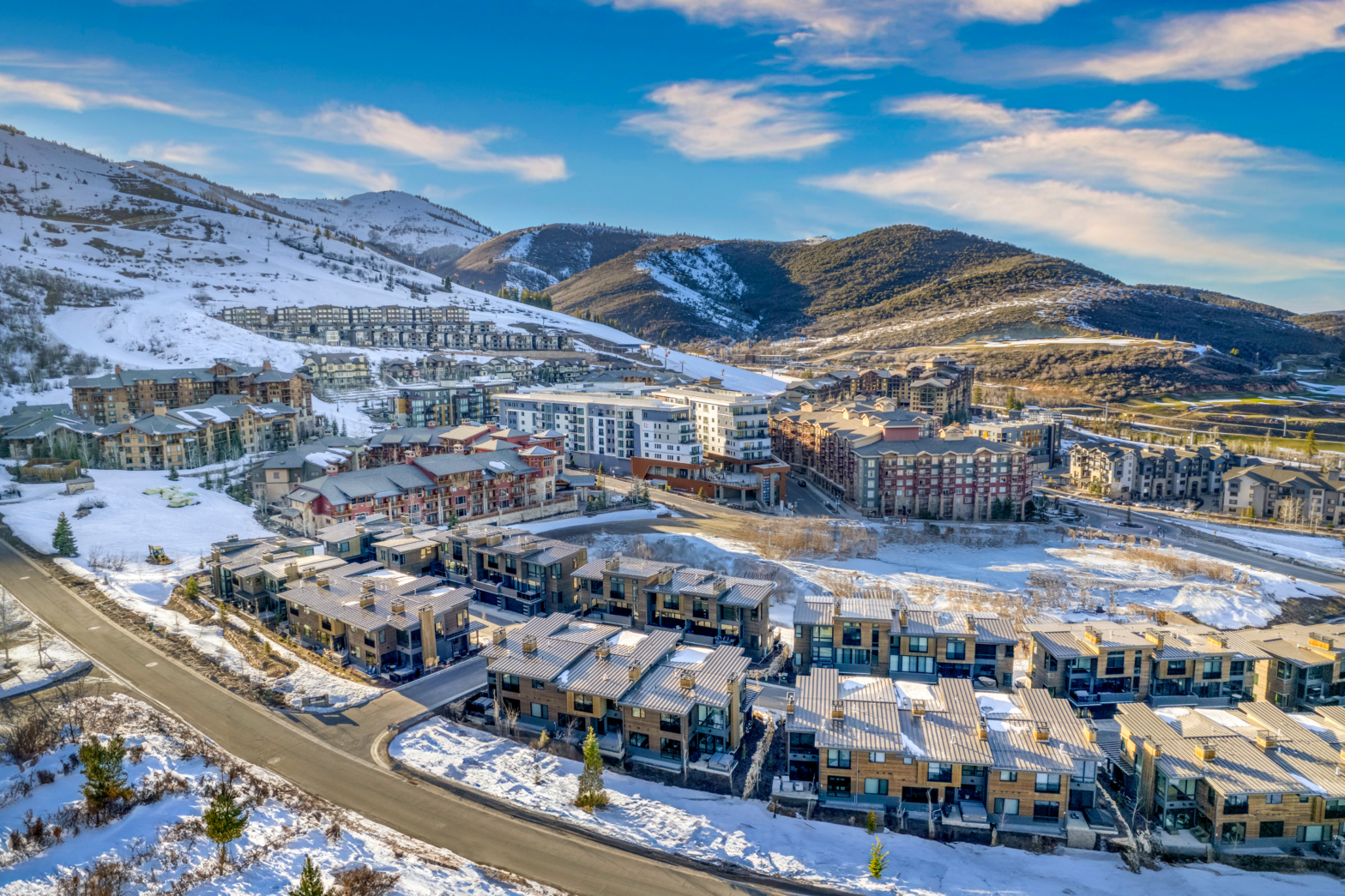 multiple buildings in a ski town mountain location with snow and powder