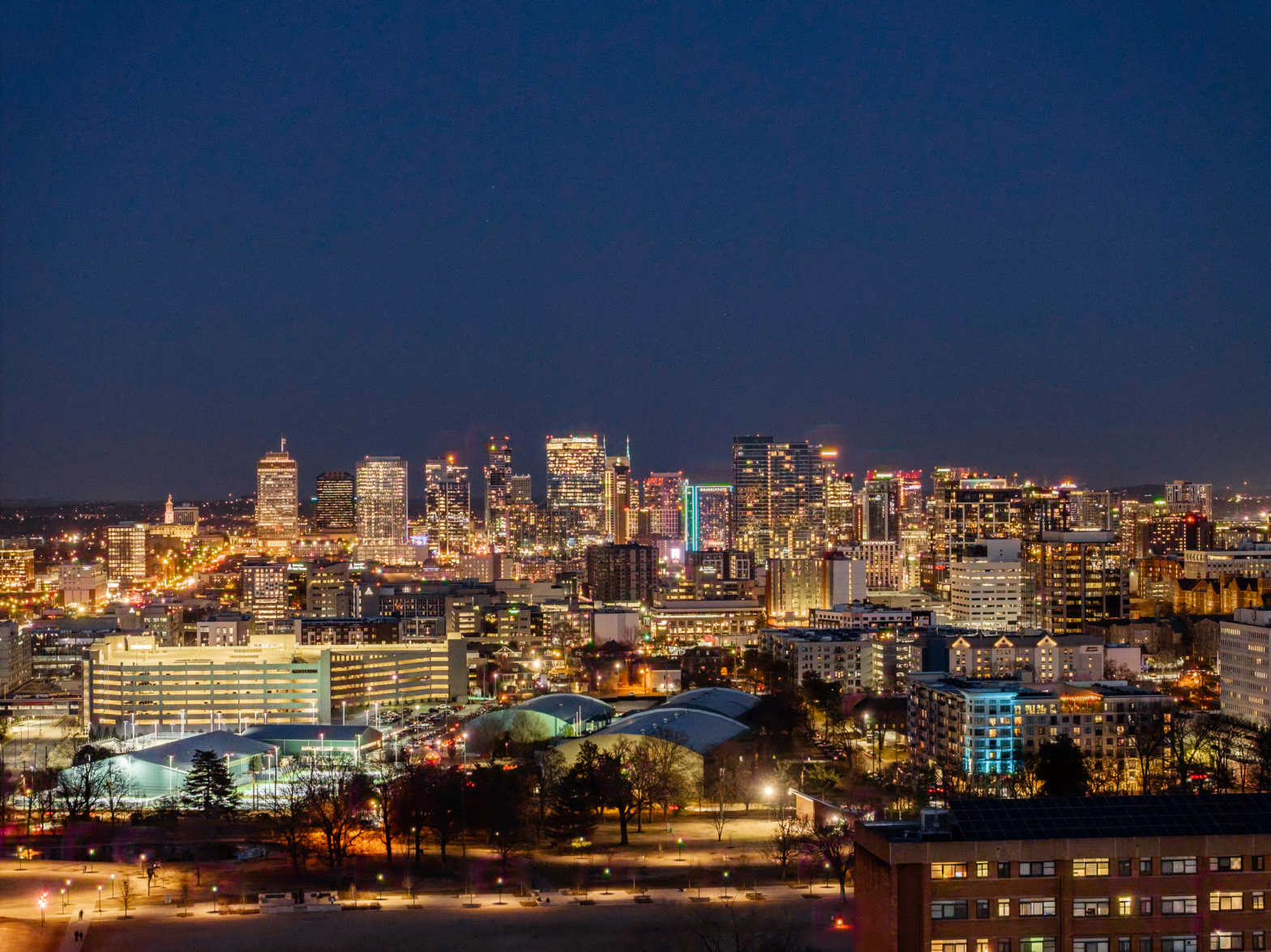night view of the high rise buildings with city lifghts and buzzing roads